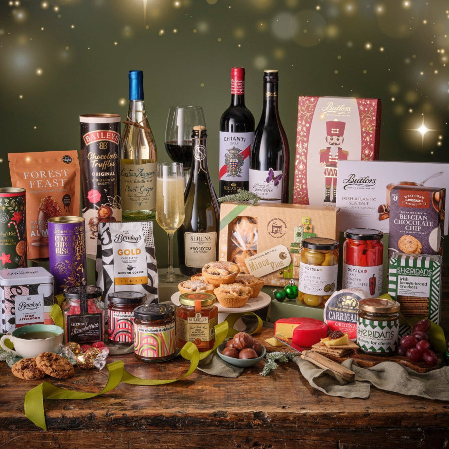 Assorted food and wine products on a wooden table with a festive background.