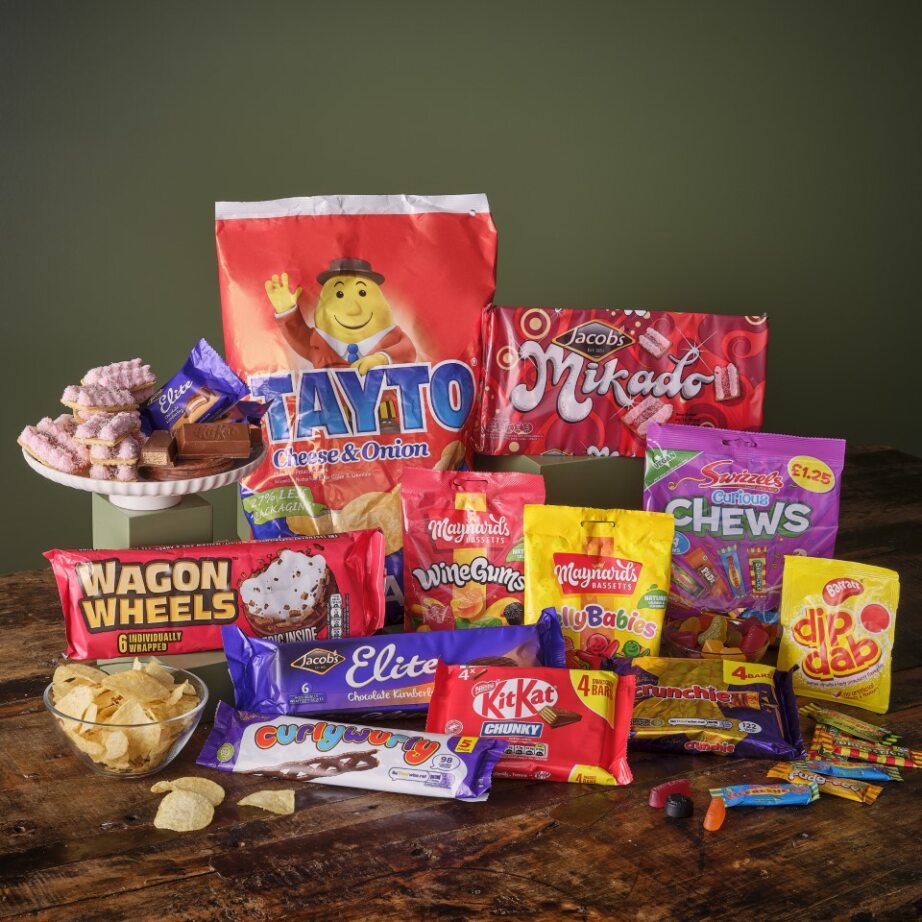 Colorful Ireland snack hamper with Tayto cheese and onion crisps, Jacobs treats, and assorted sweets.