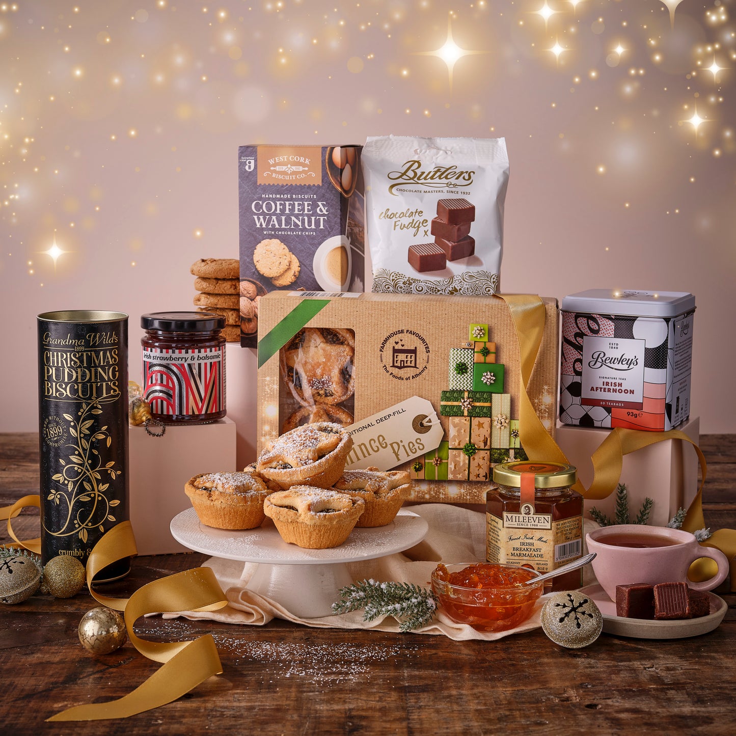 Assorted food items including pies, cookies, and a mug on a wooden table with a festive background.