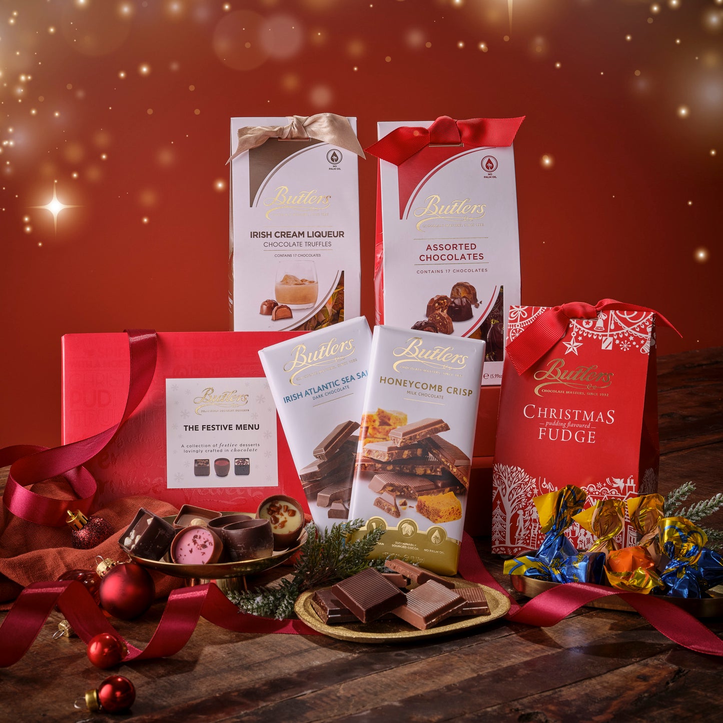 Butlers chocolate products including boxes, packets, and fudge on a festive background with red and gold colors.