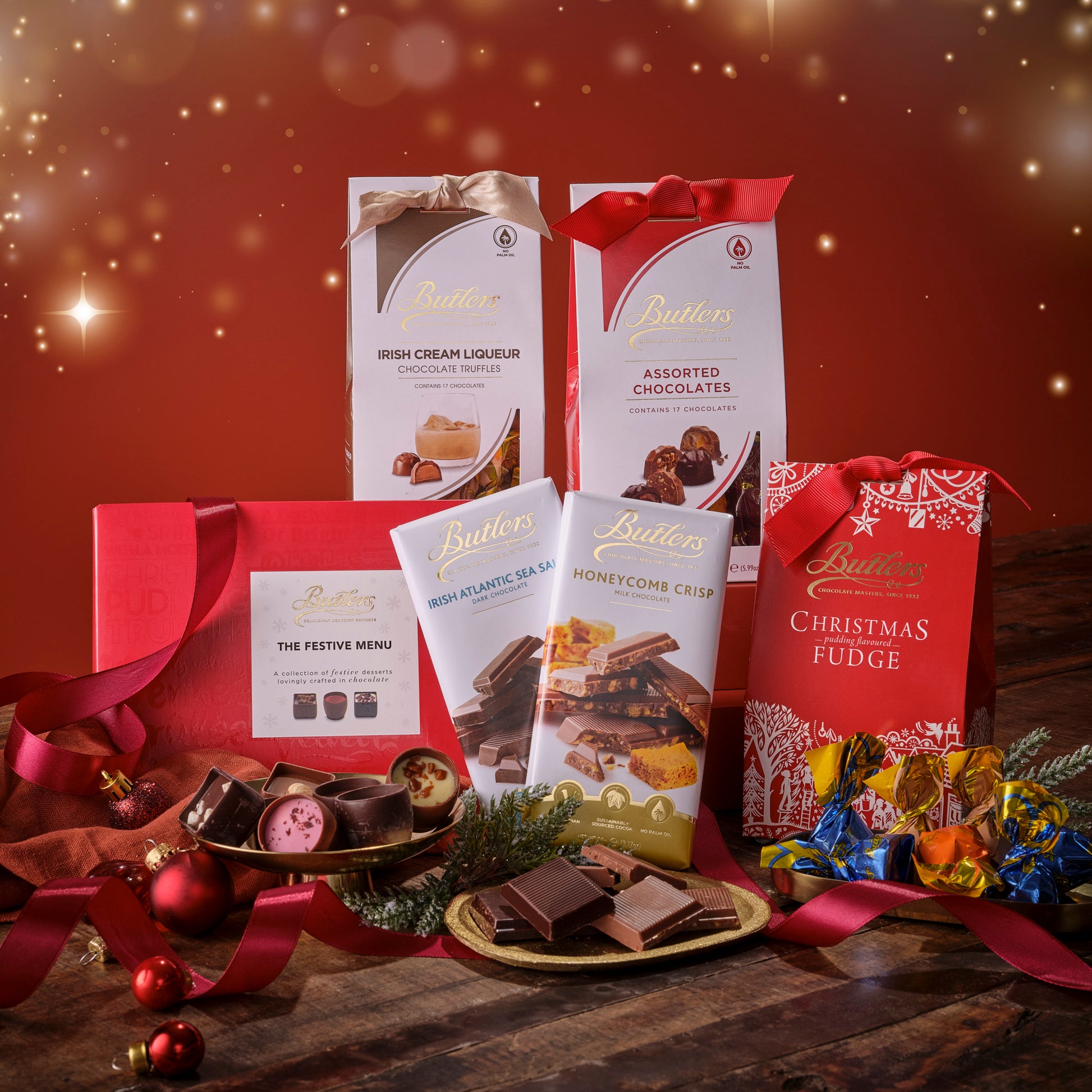 Butlers chocolate products including boxes, packets, and fudge on a festive background with red and gold colors.