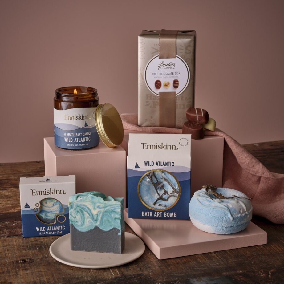 Enniskinn Wild Atlantic Way Giftset with soaps bath bombs and a chocolate box arranged on pastel pink display stands.