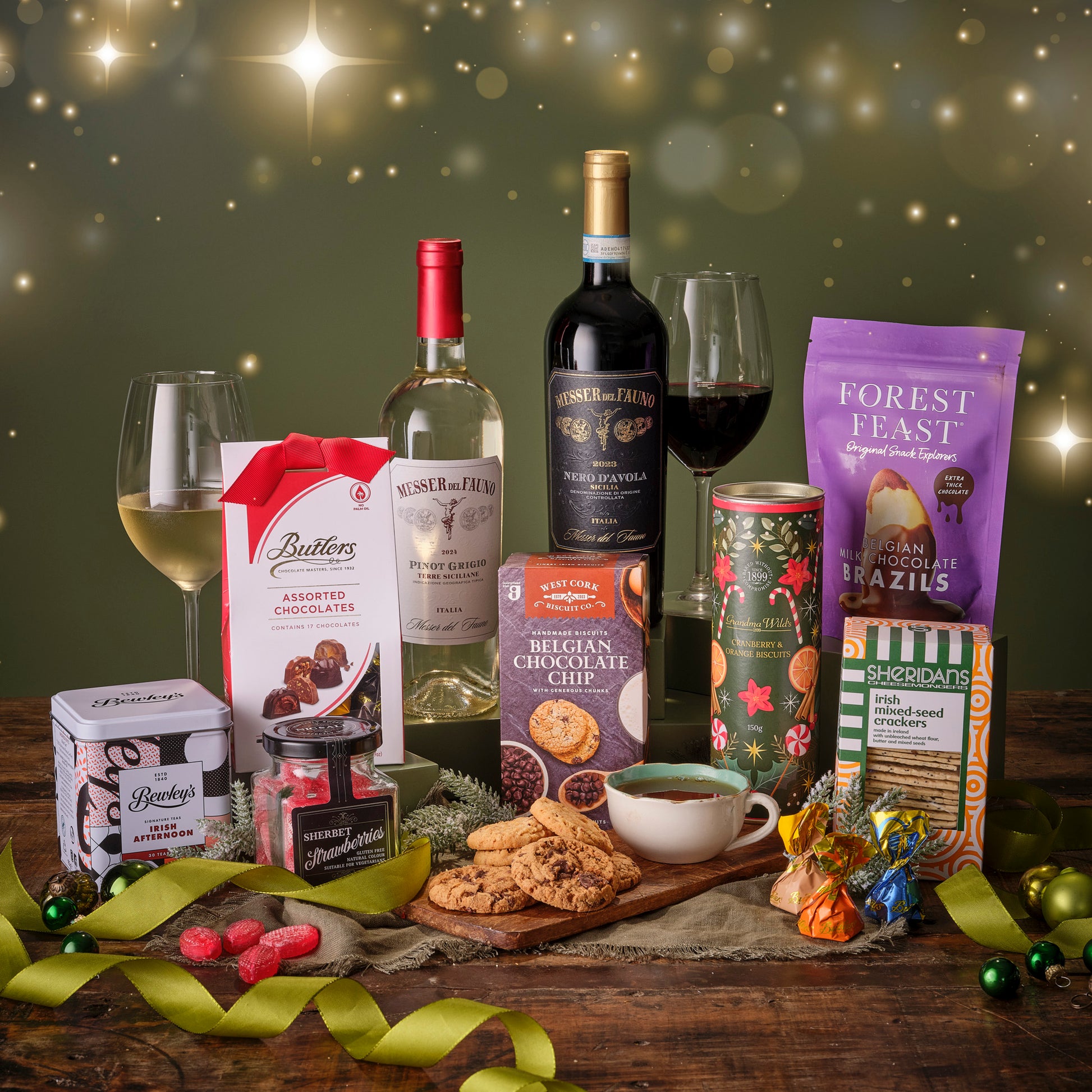 Assorted food and wine items on a wooden table with a festive background.