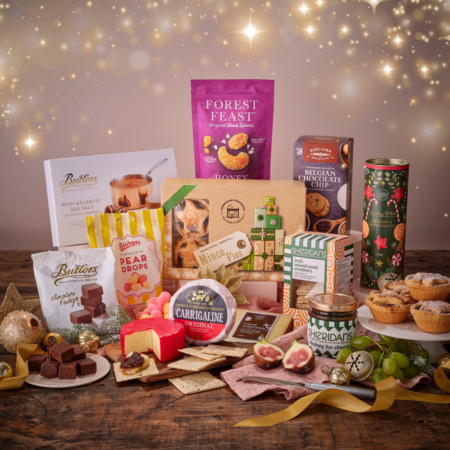 Assorted gourmet food items on a wooden table with a festive background