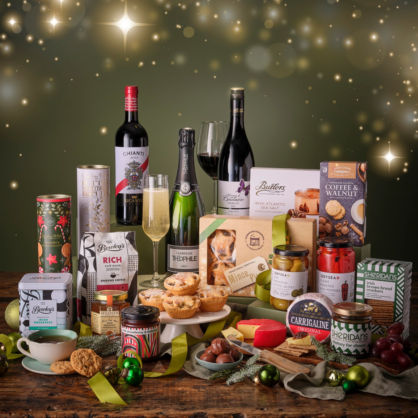 Assorted gourmet food and wine items on a wooden table with a festive background.