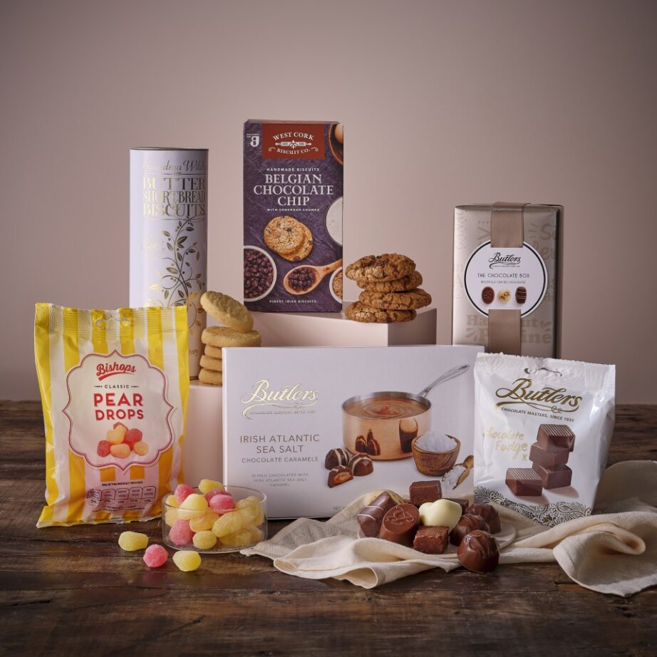 Sweet Treats Hamper with pear drops bag biscuits cookies and chocolate boxes displayed on a wooden table