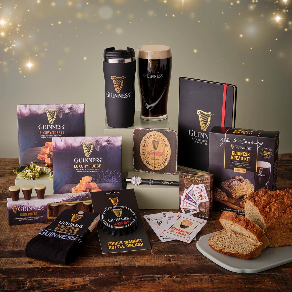 Collection of Guinness-themed products including a mug, loaf of bread, and various items on a wooden surface.