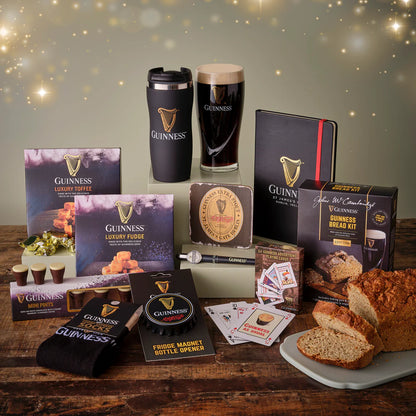Collection of Guinness-themed products including a mug, loaf of bread, and various items on a wooden surface.
