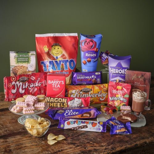 Not Before Your Dinner Hamper filled with Tayto crisps Cadbury Roses chocolates and other snacks.