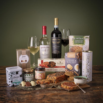 Thinking of You Hamper arranged with wine bottles and an assortment of snacks on a wooden table