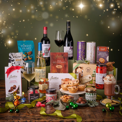 Assorted holiday food and drink items on a wooden table with a festive background.