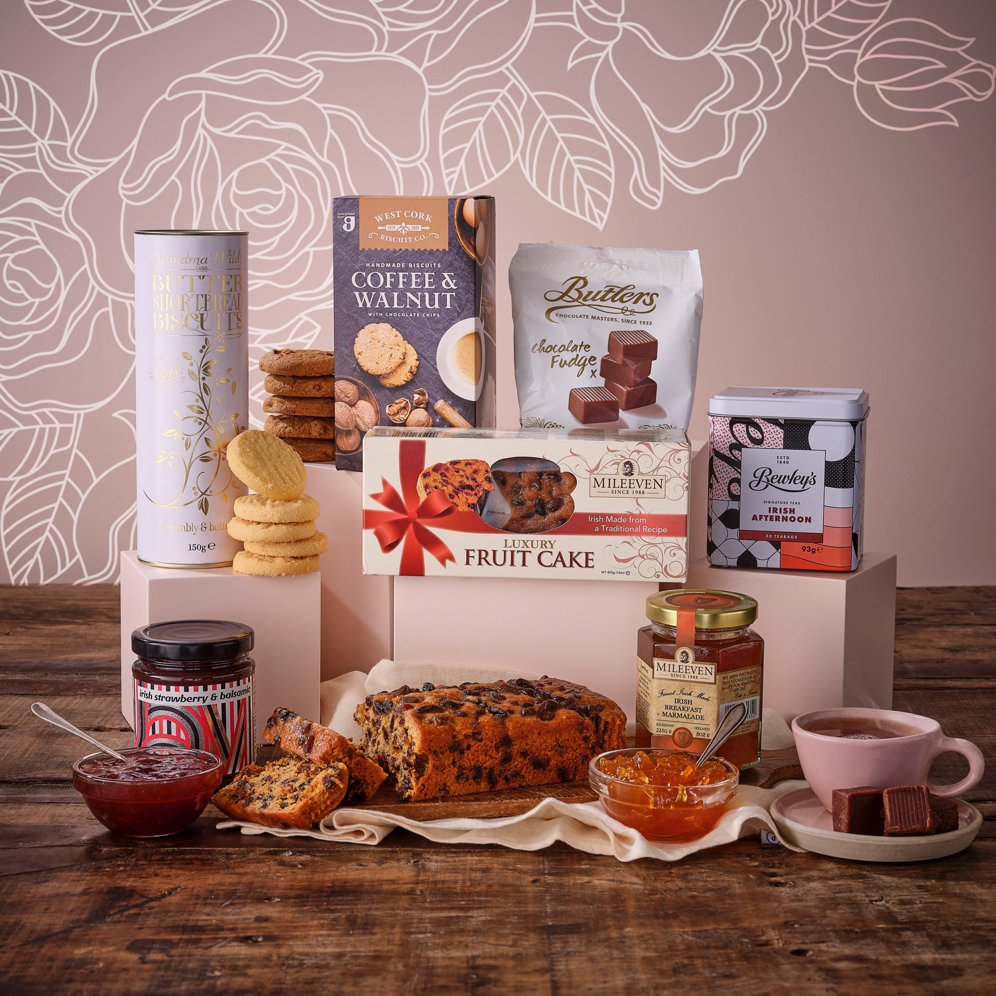 Mother’s Day Afternoon Tea Hamper with biscuits chocolates fruit cake and jam on a pink display