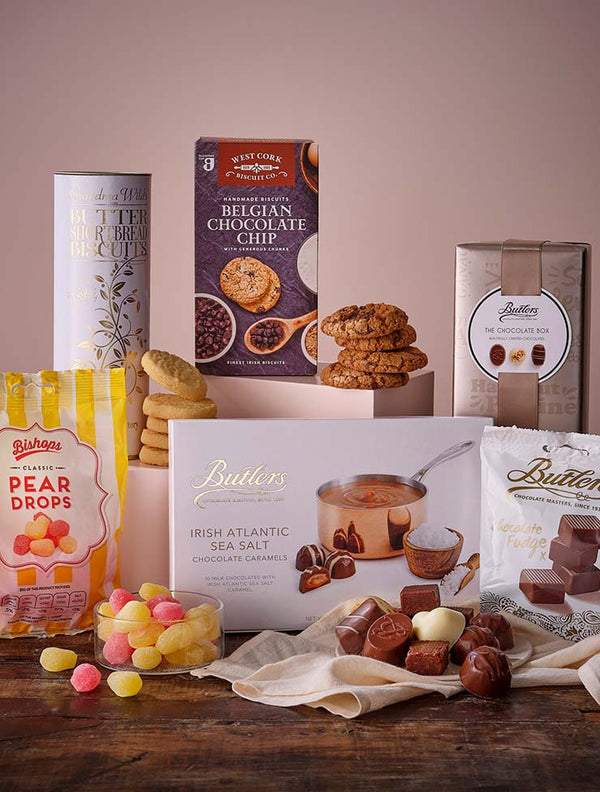 Assorted Sweets, Butlers chocolates and decorative items on a wooden board with blurred background
