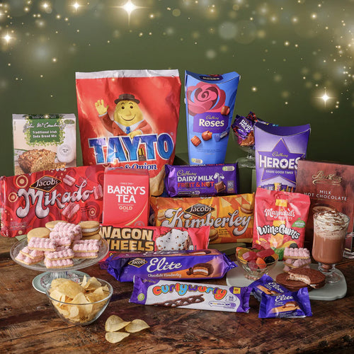 Assorted snacks and candies on a wooden table with a festive background