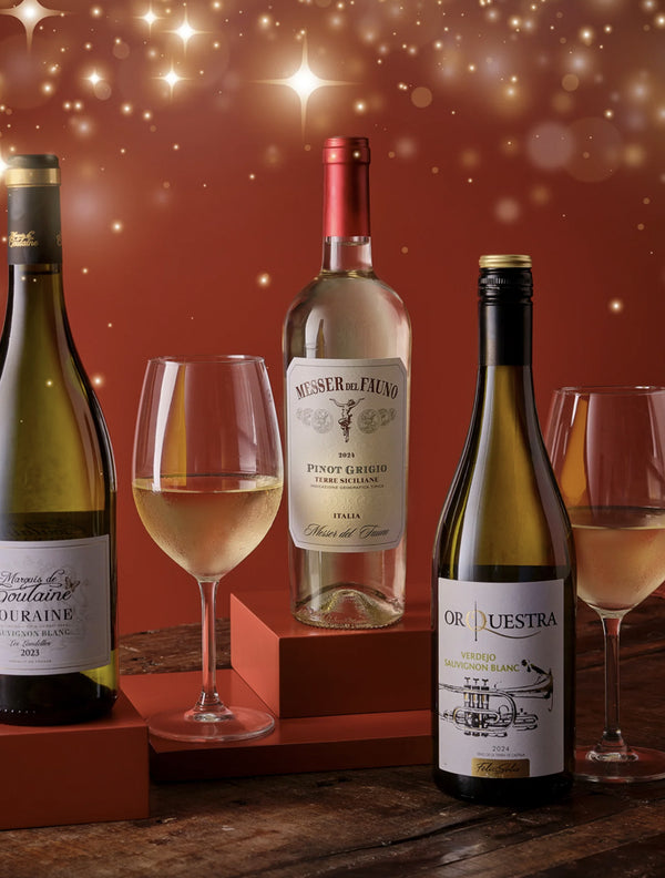 Wine bottles and glasses on a wooden surface with a warm, glowing background