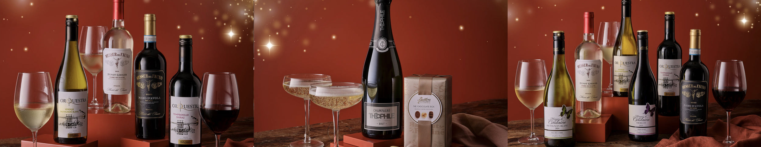 Wine bottles and glasses on a wooden table with a warm, red background