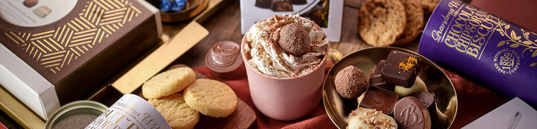 Assorted chocolates and cookies on a wooden table